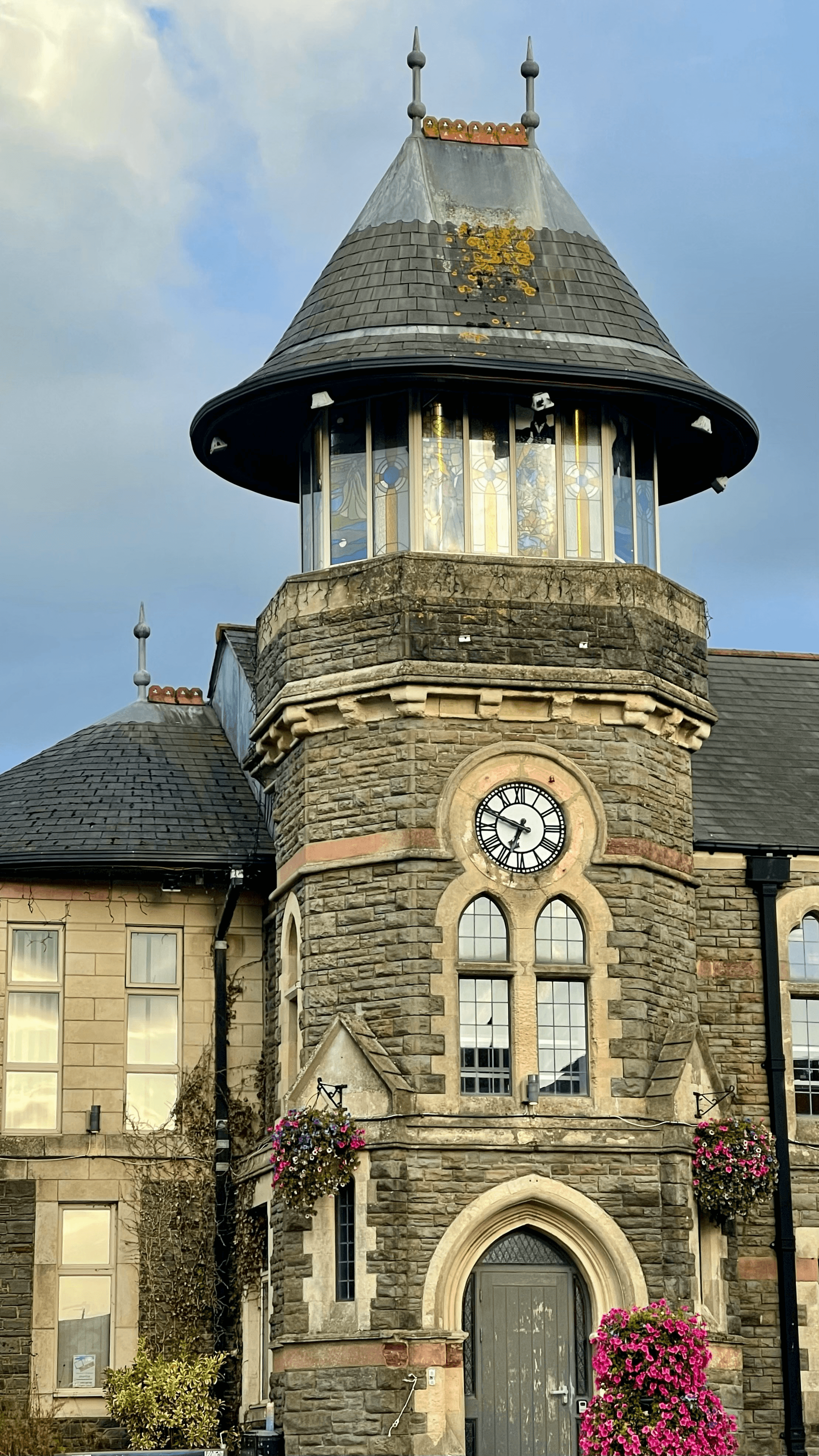 Caerphilly town centre clock tower with flowering baskets
